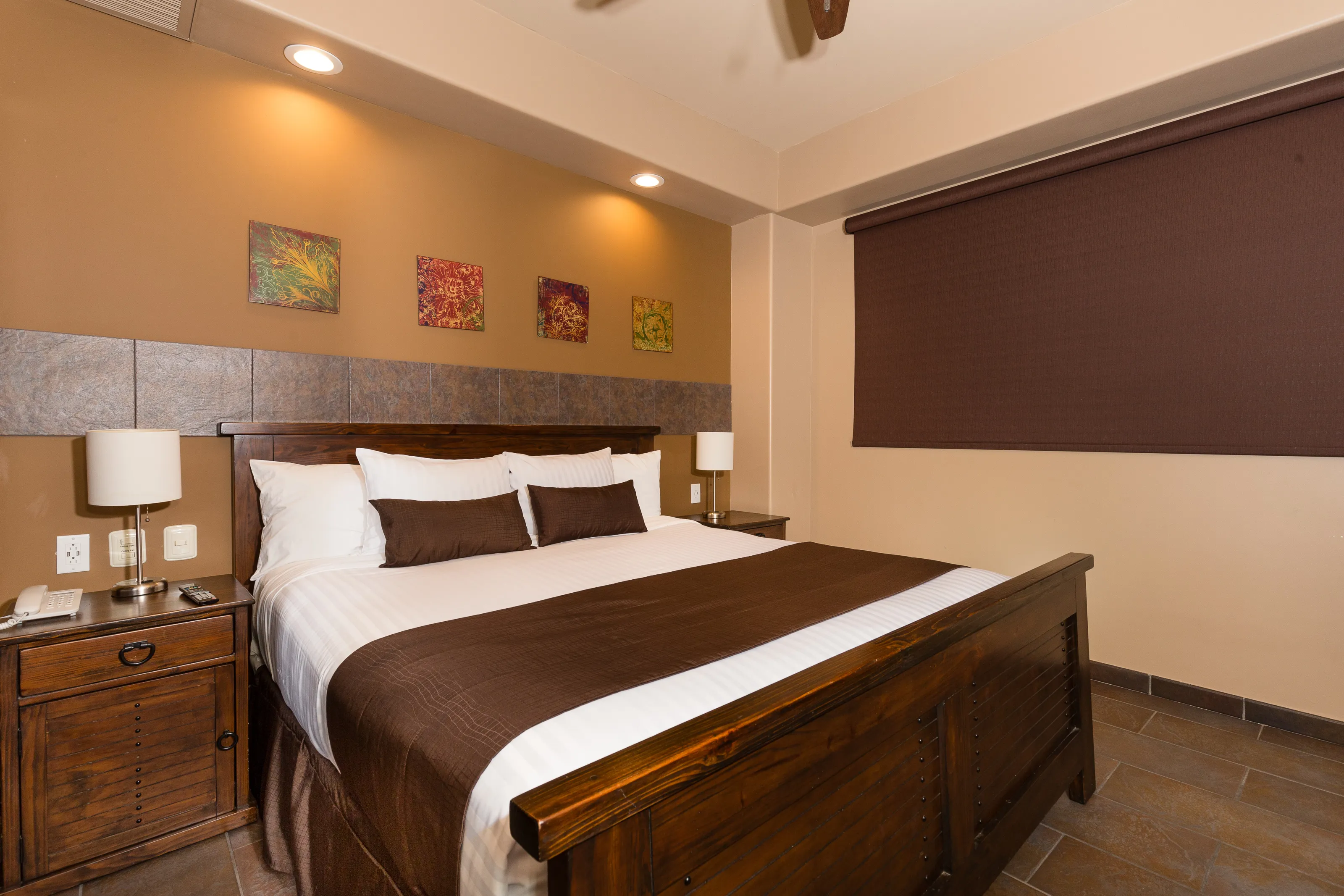 Cozy bedroom with wooden bed and warm brown decor.