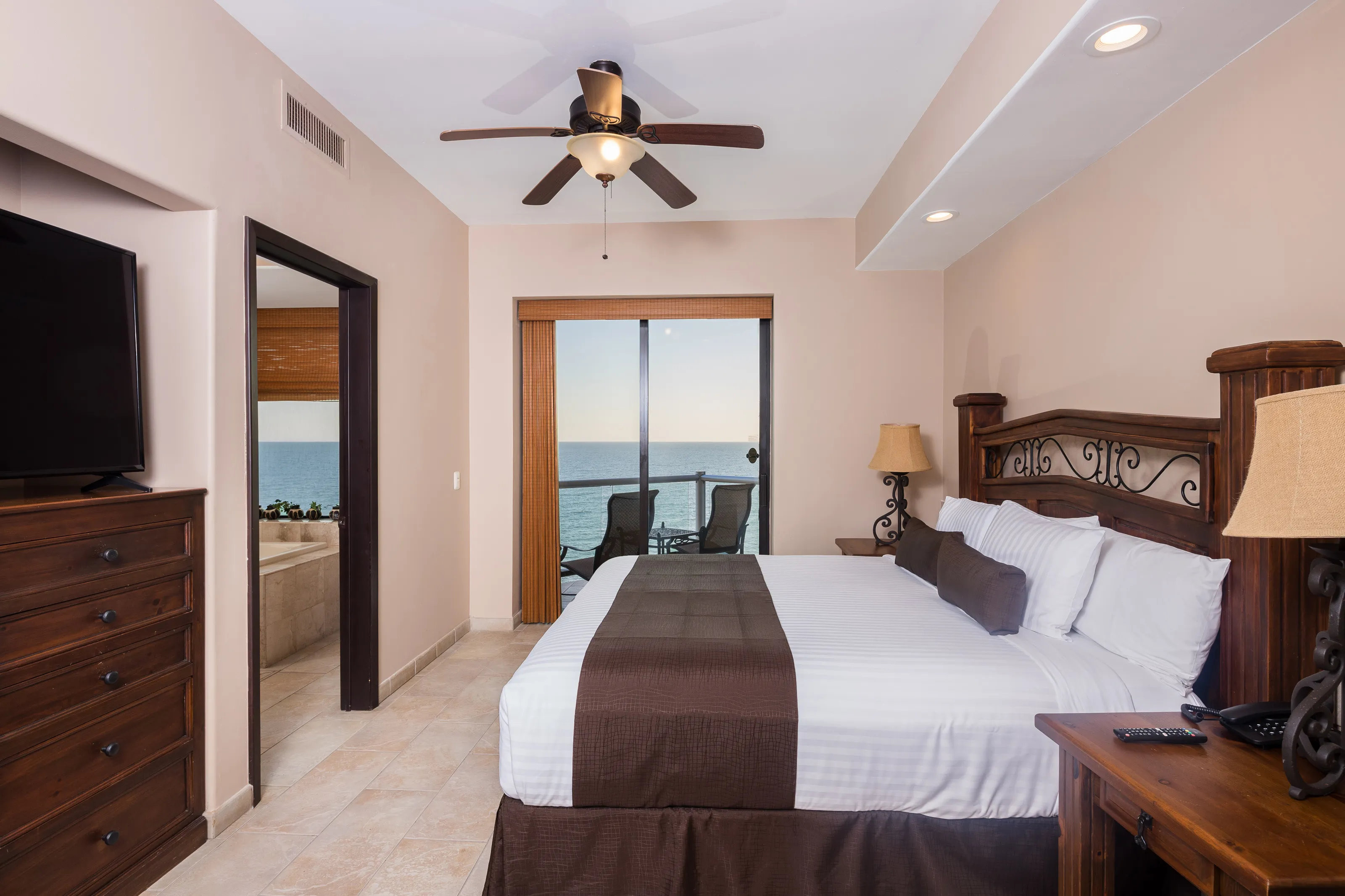 Bright bedroom with ocean view and modern decor.