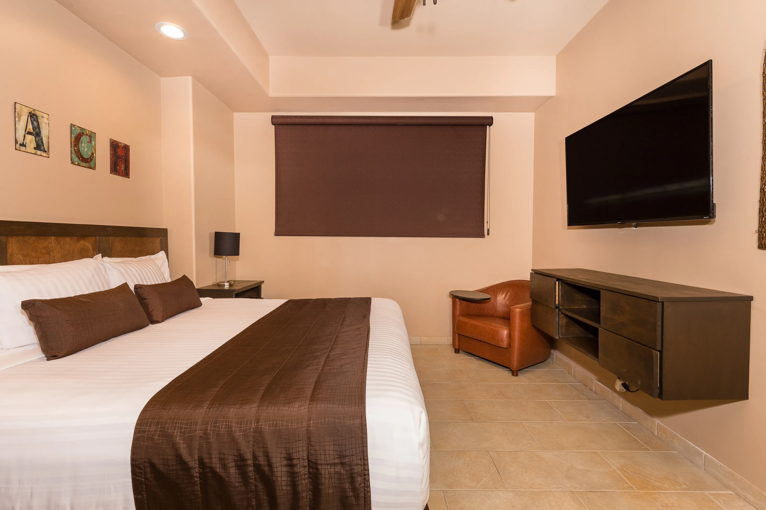 Cozy hotel room with a large bed and a wall-mounted TV.