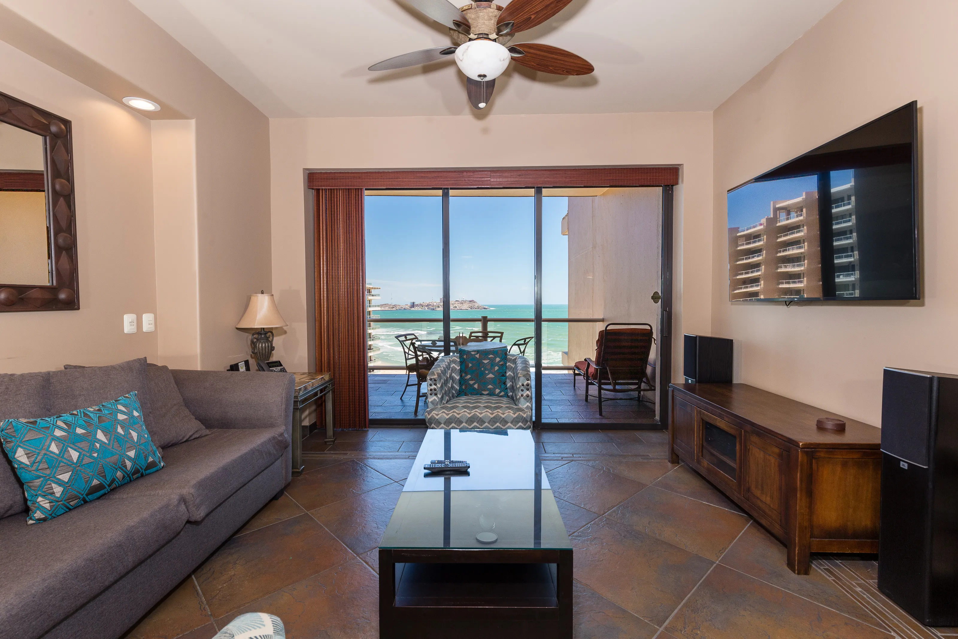 Cozy living room with a sea view and balcony seating.